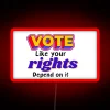 Neon sign reading 'Vote Like Your Rights Depend on It'