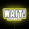 Neon sign with colorful design reading 'Wait, there's a bird!' above a yellow background.