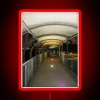 Neon lights illuminate a modern walkway at night