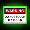 Warning neon sign indicating danger around tools and equipment.