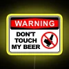 Warning neon sign with a red prohibition symbol and "don't touch my beer" written in bold, yellow letters.