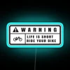 Neon warning sign with blue glow on a dark background.