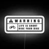 Neon warning sign with bold red and green colors on a white background.