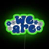 Neon sign with RGB color scheme, highlighting green hue in urban setting.