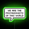 Neon sign with bold, colorful letters spelling out 'We Are The Protagonists Of This World'