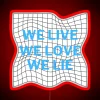 Neon sign with colorful, abstract text "We Live Love Lie" in bold, cursive font.