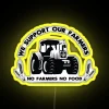 Neon sign artwork displaying solidarity with farmers in bold, colorful letters.