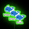 Large, colorful neon sign featuring a stylized whale design in green tones.