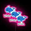 Neon whale sign in pink, RGB colors on a black background.