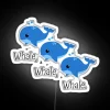 A neon whale sign against a dark background, highlighted with RGB colors.