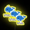 RGB neon whale sign against a yellow background
