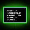Neon sign with colorful, glowing letters reading 'What a horrible night to have a curse'
