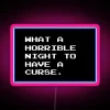 Neon sign with pink letters reading 'What a horrible night to have a curse'