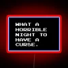Neon sign with RGB colors depicting a cursed night in bold red letters.