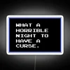 Neon sign with curse-themed LED lights glowing in dark alleyway at night.