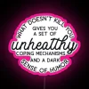 Neon sign reading "What Doesn't Kill You Disappoints Me" with pink neon lights.