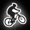 Mountain bike rider performing wheelies on a rugged terrain with vibrant neon lighting.