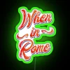 Neon sign in Rome with green LED lights spelling out 'When in Rome'