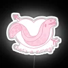 Eel biting knee on a neon sign in a beachy environment.