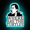 Turtle logo on a neon sign in front of a cityscape at sunset