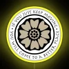 Neon sign featuring a white lotus design in bold, colorful RGB style on a bright yellow background.