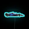 Williams F1 team 2023 car FW45 with drivers Alex Albon and Logan Sargeant in neon-lit RGB colors.