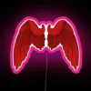 Neon pink wings illuminated sign against dark background