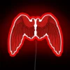 Neon red wings sign with colorful LED lights illuminated in a city nightlife scene.