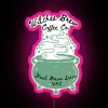 Neon sign with pink glow reading "Witches Brew Coffee Co" in bold, cursive font.