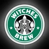 Neon sign featuring a colorful, glowing cauldron with swirling potions.