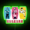 Neon sign with bold, colorful letters reading 'Women Can Be Heroes'