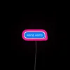 Neon sign with pink letters displaying a womp womp sound effect.