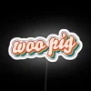 Retro neon sign with cartoon pig design in white color scheme.