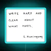 Neon sign with bold, vibrant letters reading 'Write hard and clear about what hurts'