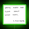 Neon sign with bold, green letters reading 'Write hard and clear about what hurts'