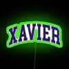 Neon sign with curved font reading Xavier College in green RGB color scheme.