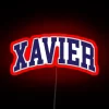 Neon sign reading Xavier College with curved font in red color.