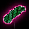 Neon green yarn skein with pink highlights on a dark background