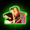 Ranbir Kapoor and Deepika Padukone from Yeh Jawaani Hai Deewani, lit up by a neon sign in green.