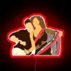 Ranbir Kapoor and Deepika Padukone pose in front of a neon sign from the movie Yeh Jawaani Hai Deewani.