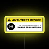 Yellow anti-theft device warning sign with manual transmission 5 speed icon in RGB neon design