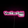 Neon pink sign with bold, cursive letters reading 'Yes I'm Cold'