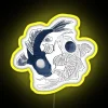 Neon sign featuring intertwined yin yang symbols with koi fish in bright yellow colors against a black background.