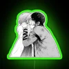 Two anime characters, Yona and Hak, stand in front of a colorful neon sign with green lights.