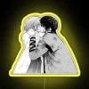 Two anime characters, Yona and Hak, standing in front of a vibrant yellow neon sign.