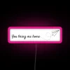 Pink neon sign with Japanese characters reading 'You bring me home'