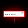 Neon sign with RGB lights spelling out "You Bring Me Home" in a modern, cursive font.