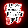 Girl holding neon sign with inspirational message in a vibrant, colorful setting.