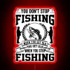 Neon sign with colorful letters reading "You Don't Stop Fishing When You Get Old" against a dark background.