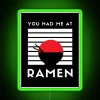A colorful, glowing neon sign reading 'You Had Me at Ramen' in bold green letters.